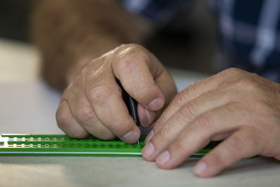 Close-up of man working on table