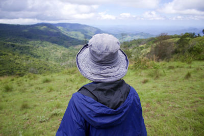 Rear view of woman on landscape against sky