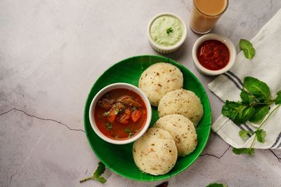 Rava idlis with sambar chutney and tea - south indian breakfast top down view