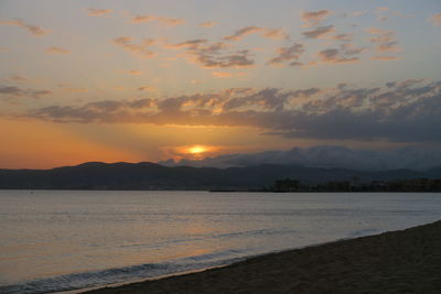 View of sea against cloudy sky during sunset