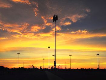 Scenic view of road against sky at sunset