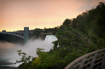 View of bridge over river against sky during sunset