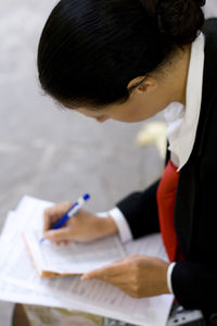 Side view of young woman working at table