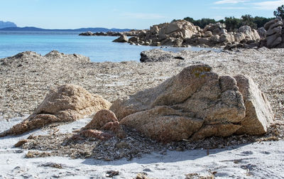 Rocks on beach against sky