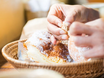 Close-up of woman preparing food in basket