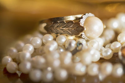 Close-up of pearl jewelries on table