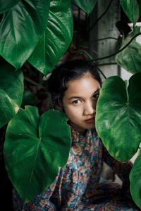 Portrait of a girl with green leaves