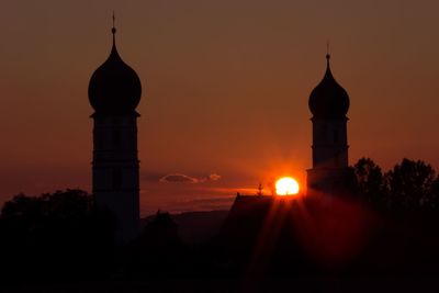 Silhouette building against sky during sunset