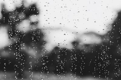 Full frame shot of wet glass window in rainy season