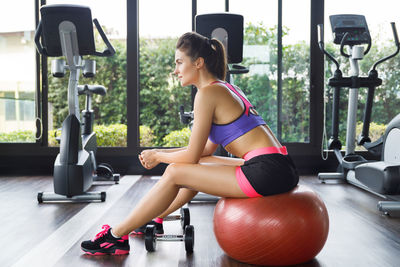 Young woman exercising in gym