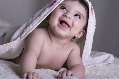 Portrait of cute baby boy on bed