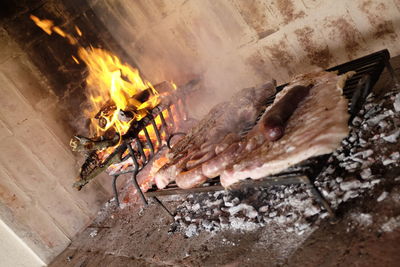 High angle view of meat on barbecue grill