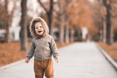 Cute baby girl 1-2 year old wearig casual stylish cloth walk in autumn park 