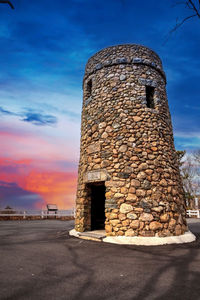 Sunset over tall cobblestone structure of scargo tower in dennis, cape cod, massachusetts