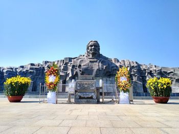 Statue of temple against clear blue sky