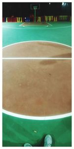 Low section of man playing with ball in swimming pool