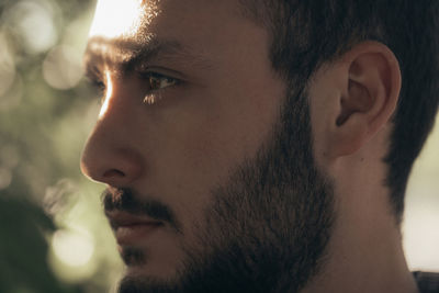 Close-up of bearded man looking away