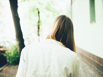 Rear view of woman walking on street