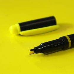 Close-up of yellow pen on table