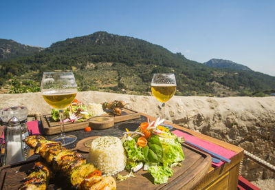 View of drink on table against mountains