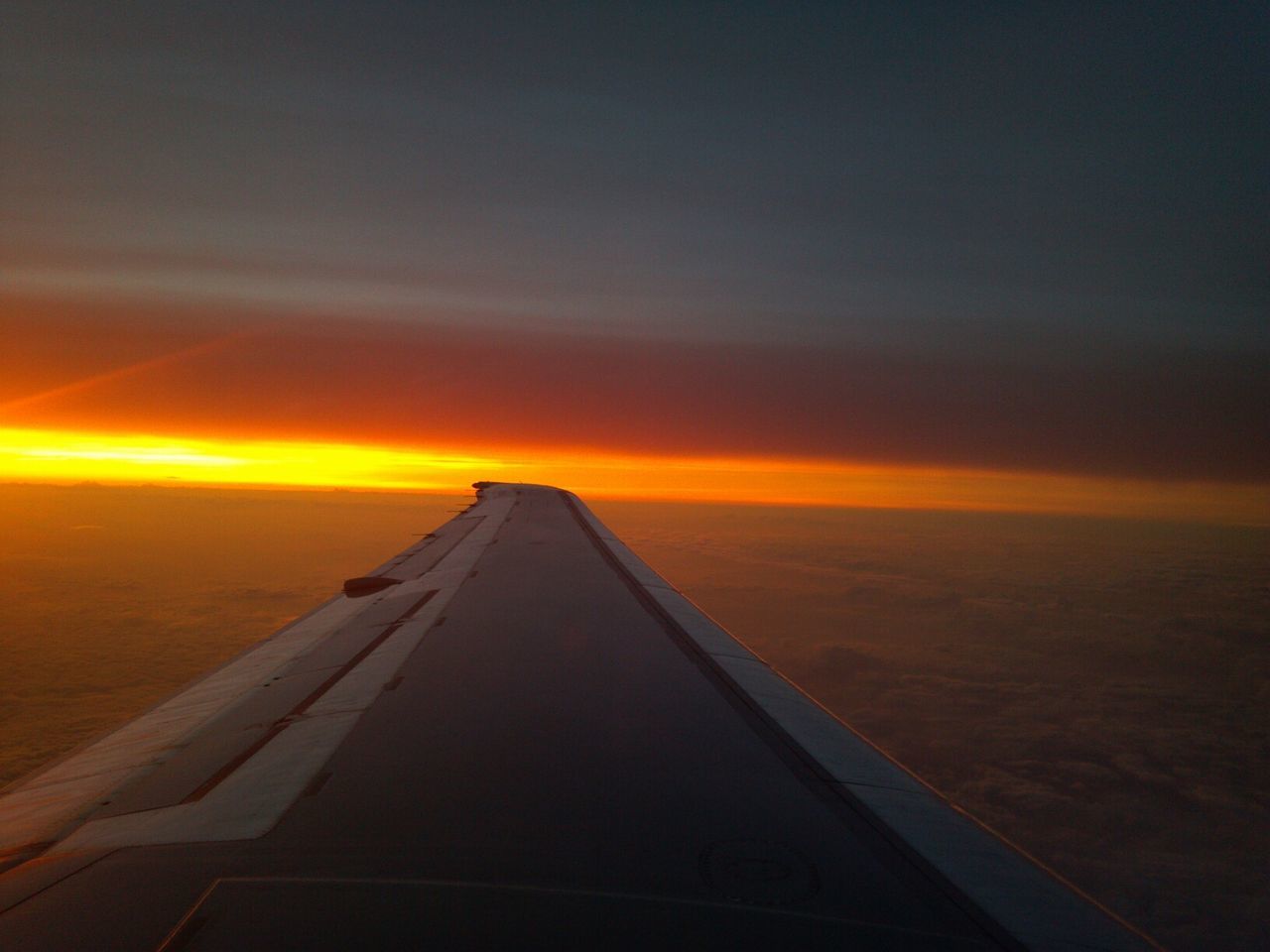 sunset, transportation, sky, airplane, orange color, cloud - sky, scenics, part of, beauty in nature, aircraft wing, mode of transport, nature, cropped, no people, dusk, air vehicle, the way forward, outdoors, tranquility, cloud