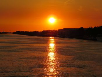 Scenic view of sea against romantic sky at sunset