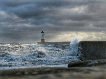 Scenic view of sea against cloudy sky
