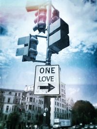 Low angle view of road sign against cloudy sky