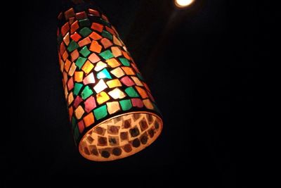 Close-up of illuminated lights over black background