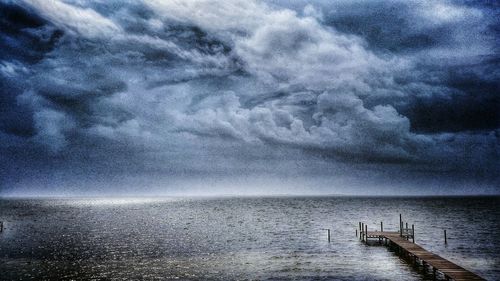 Scenic view of sea against cloudy sky