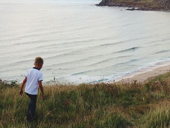 Rear view of man looking at sea shore