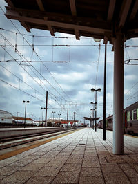 Railroad tracks in city against sky