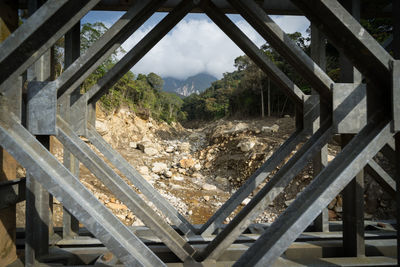 Metal bridge against forest