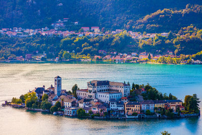 Scenic view of river by buildings in city