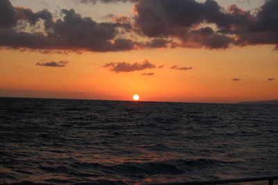 Scenic view of sea against orange sky