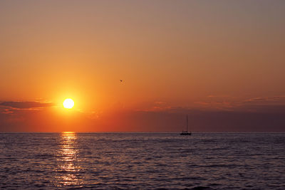 Scenic view of sea against romantic sky at sunset