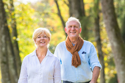 Portrait of smiling woman against trees