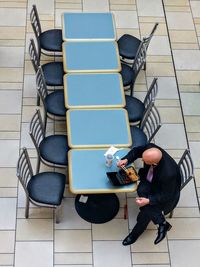 High angle view of man sitting on chair