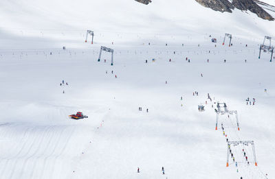 People skiing on snow covered field