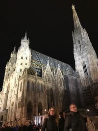 Group of people in front of building at night