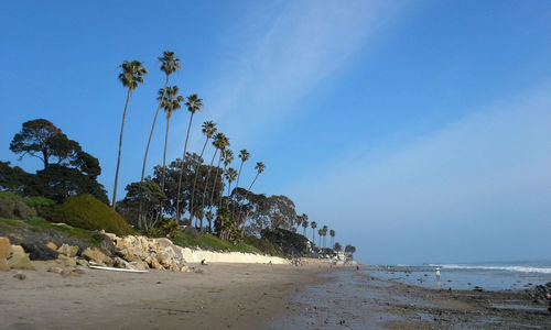 Scenic view of beach against cloudy sky