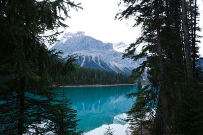 Scenic view of lake against snowcapped mountain during winter