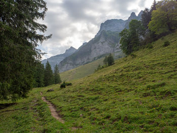 Scenic view of mountains against cloudy sky