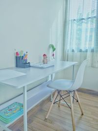 Chairs and table against window at home