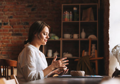Young woman sitting at table in cafe