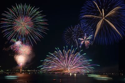 Low angle view of firework display at night