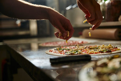 Midsection of person preparing food in kitchen