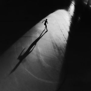 High angle view of silhouette woman ice-skating