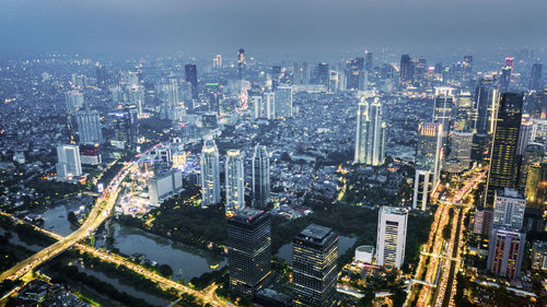 High angle view of modern buildings in city against sky