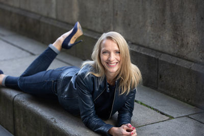 Portrait of young woman sitting on staircase